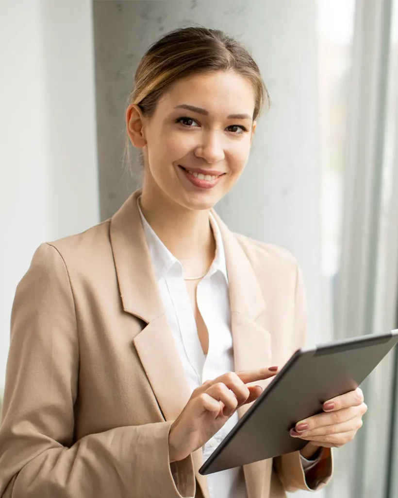 young-woman-holding-digital-tablet-in-modern-offic-MDR8BDP